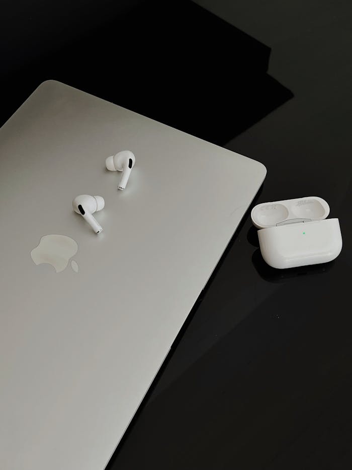 White AirPods Pro on Gray MacBook